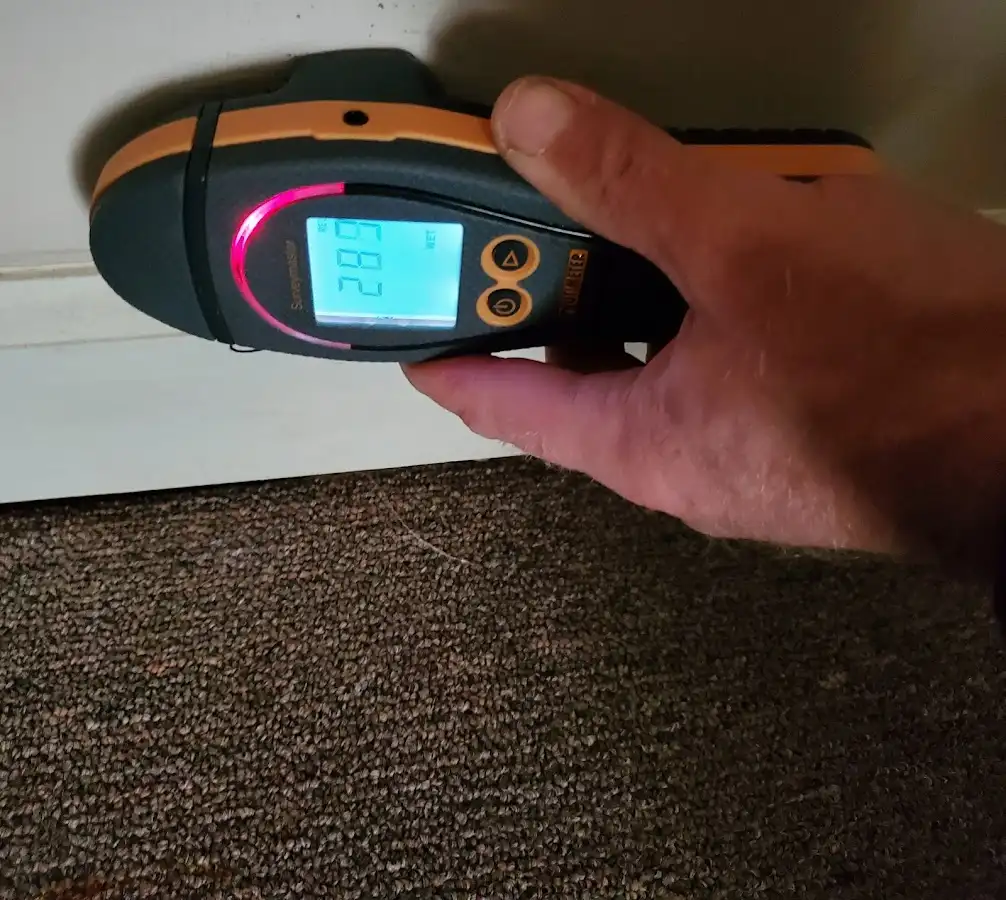Moisture detection at baseboard during Storm Damage Restoration in Auburndale